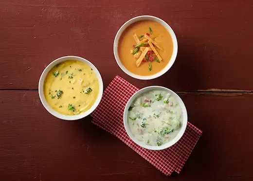 Bowls of broccoli cheddar and chicken tortilla soup